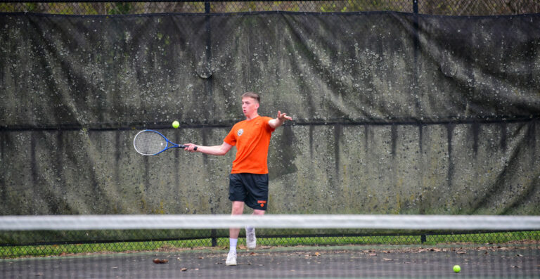 Cadet hitting tennis ball.