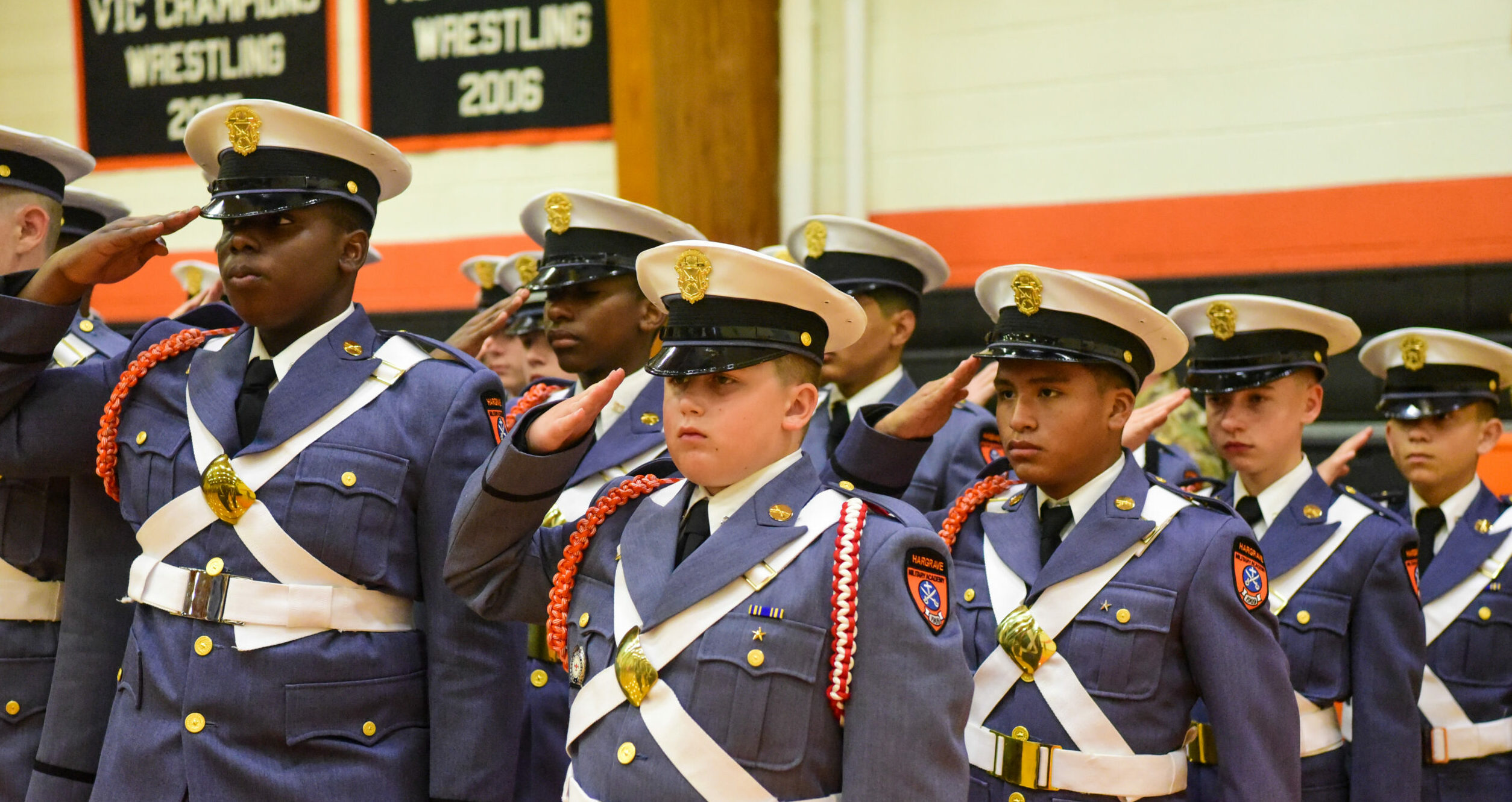 Group of cadets saluting.