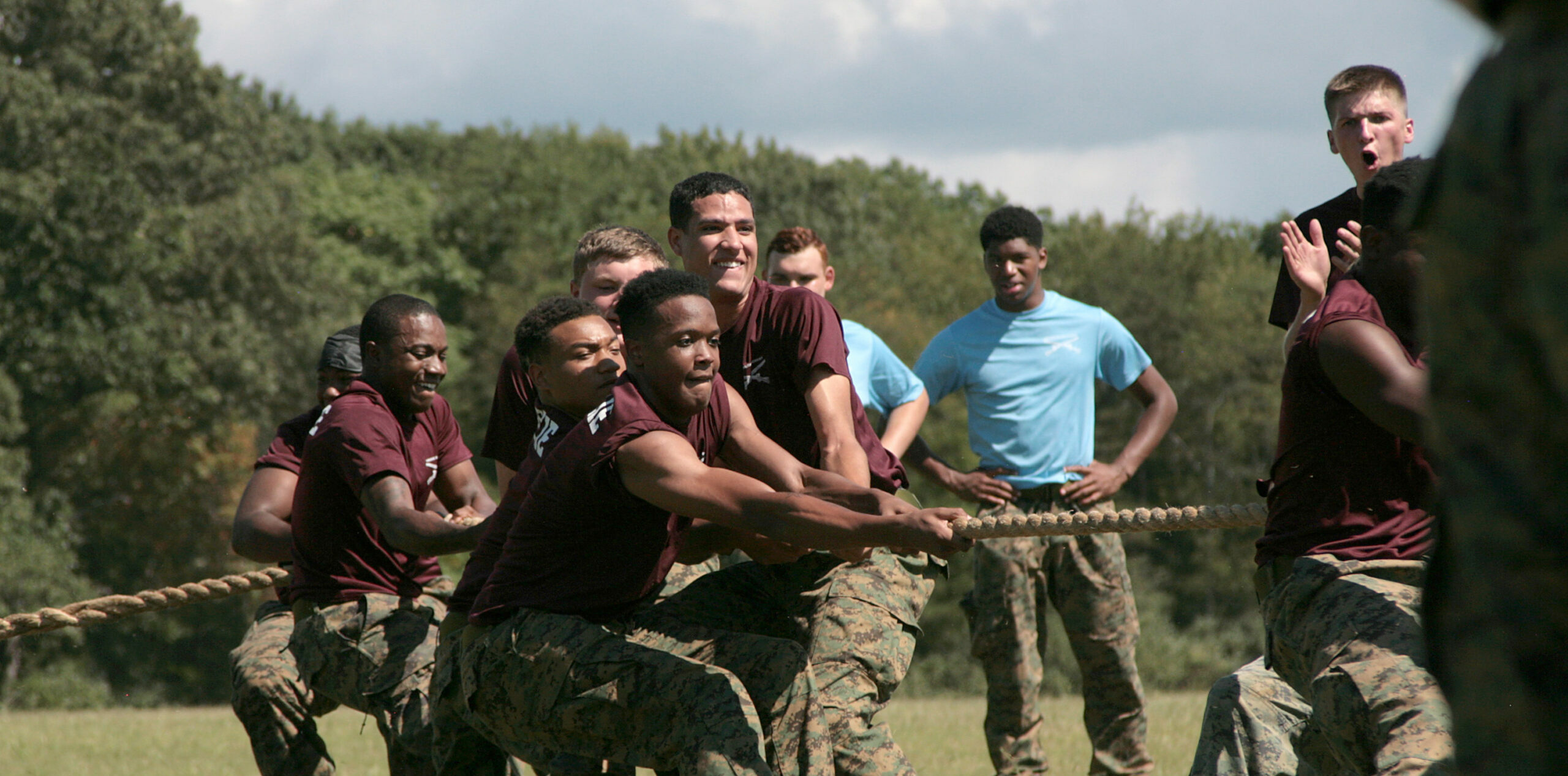 Group of cadets pulling rope in tug of war.